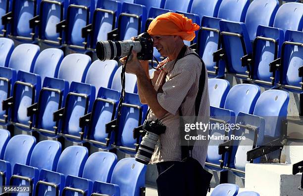 Photographer is seen during the FC Bayern Muenchen training session at the Al Nasr training ground on January 9, 2010 in Dubai, United Arab Emirates.