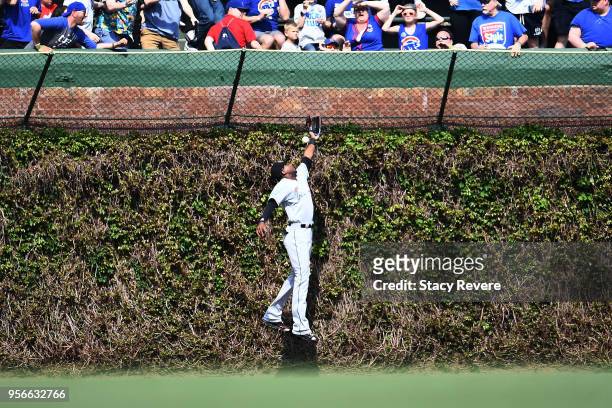 Lewis Brinson of the Miami Marlins is unable to field a fly ball during the sixth inning of a game against the Chicago Cubs at Wrigley Field on May...