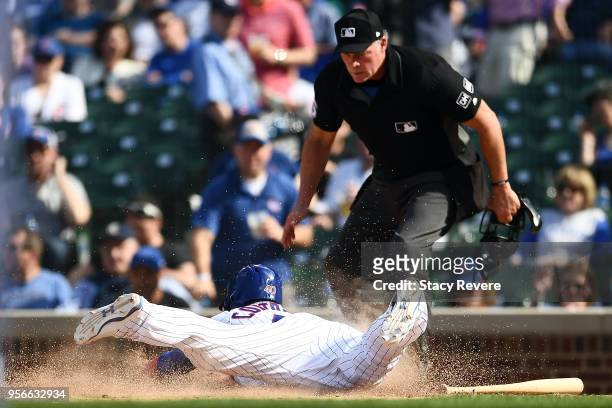 Willson Contreras of the Chicago Cubs slides safely into home during the eighth inning of a game against the Miami Marlins at Wrigley Field on May 9,...