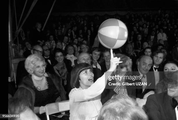 Mireille Mathieu fait tenir un ballon en équilibre sur un doigt lors d'une soirée Bouglione le 2 juin 1975 à Paris, France.