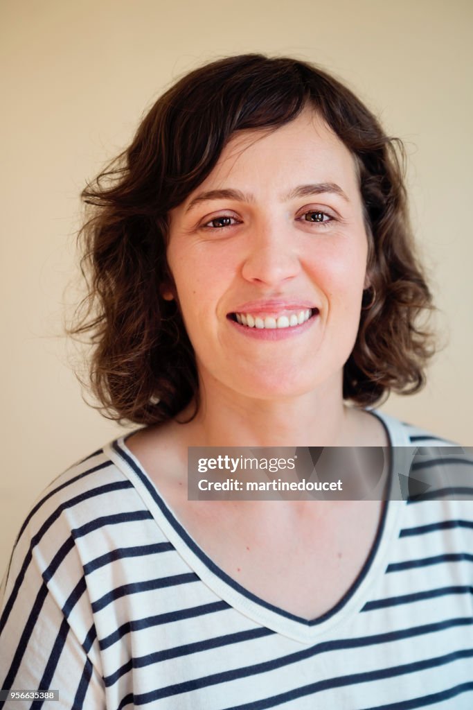 Portrait on woman in late thirties at home.