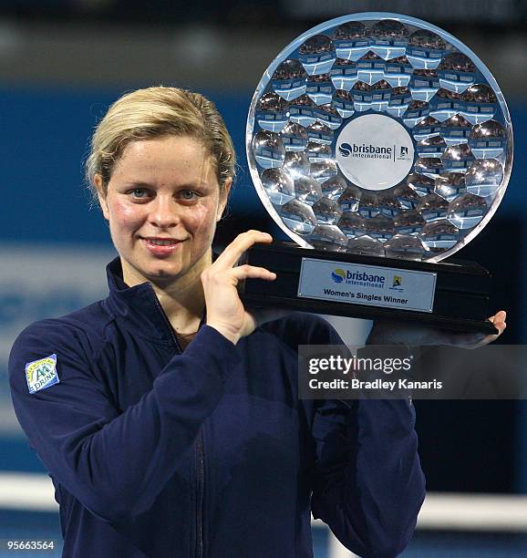 Kim Clijsters of Belgium poses with the trophy after winning the Womens final match against Justine Henin of Belgium during day seven of the Brisbane...