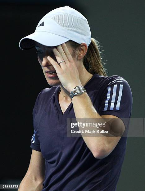 Justine Henin of Belgium reacts after losing a point in the Women's final against Kim Clijsters of Belgium during day seven of the Brisbane...