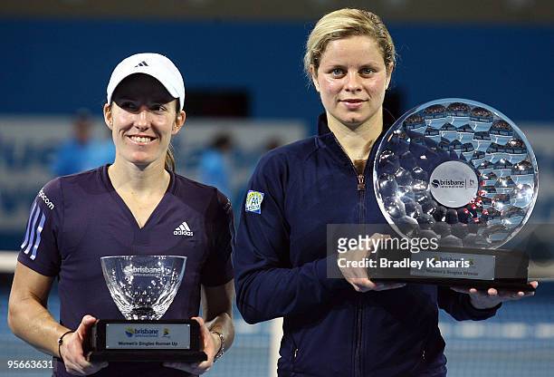 Winner Kim Clijsters of Belgium and runner-up Justine Henin of Belgium pose with their trophies after the Womens final match against Justine Henin of...
