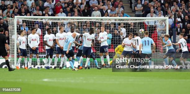 Jonjo Shelvey of Newcastle shoots over an oddly long wall of players during the Premier League match between Tottenham Hotspur and Newcastle United...