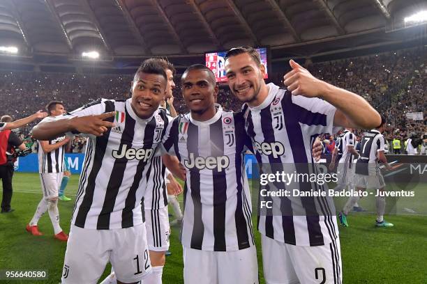 Alex Sandro, Douglas Costa and Mattia De Sciglio of Juventus celebrate after winning the TIM Cup Final between Juventus and AC Milan at Stadio...