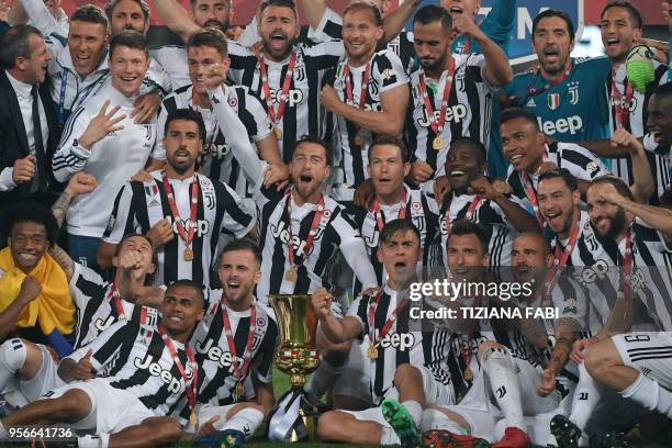 Juventus' players celebrate with the trophy after winning the Italian Tim Cup final Juventus vs AC Milan at the Olympic stadium on May 9, 2018 in...