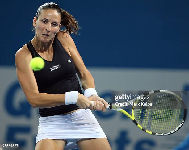 Arantxa Parra Santonja of Spain playing with Melinda Czink of Hungary plays a backhand in the women's doubles final match against Lucie Hradecka and...