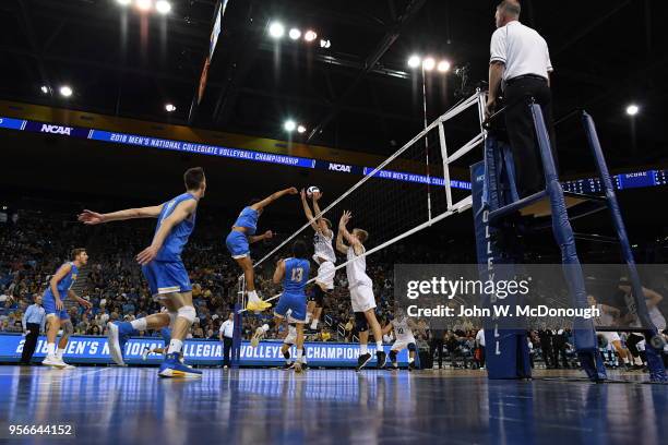 Daenan Gyimah of the UCLA Bruins spikes the ball past Simon Anderson of the Long Beach State 49ers during the Division 1 Men's Volleyball...