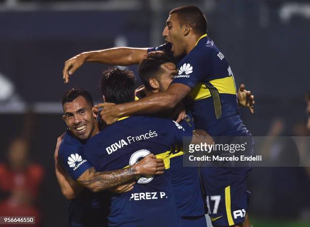 Pablo Perez of Boca Juniors celebrates with temmates Carlos Tevez, Emmanuel Más and Ramón Ábila after scoring the first goal of his team during a...