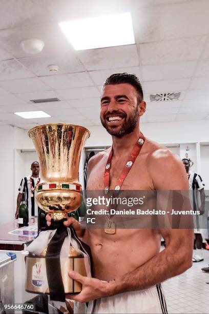 Andrea Barzagli of Juventus celebrates with the trophy after winning the TIM Cup Final between Juventus and AC Milan at Stadio Olimpico on May 9,...