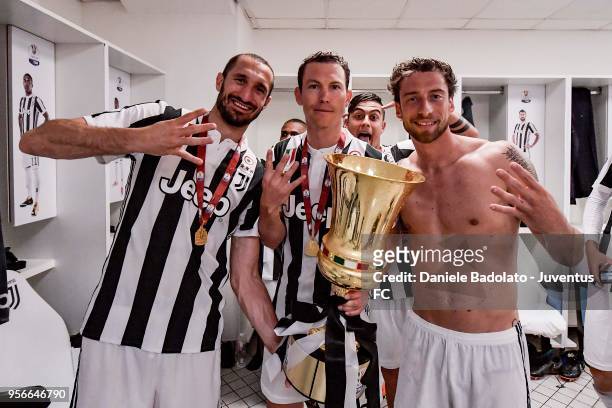 Giorgio Chiellini, Stephan Lichtsteiner, Paulo Dybala and Claudio Marchisio of Juventus celebrates with the trophy after winning the TIM Cup Final...