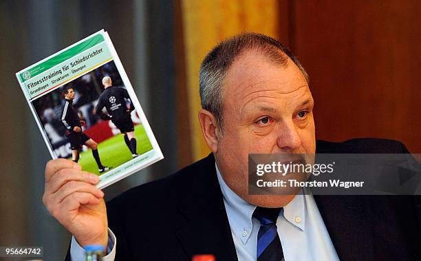 Harald Stenger, head of communication of German Football Association showes a book called "Fitness Training for referees" during the German Football...