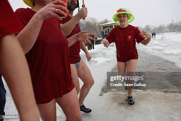 Members of the "Samsbader" ice swimming club emrge after a quick dip in the frozen Orankesee lake at the 26th annual Berlin Seals winter swim on...