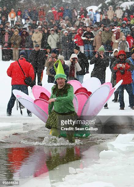 Costumed participant enters the frozen Orankesee lake for a quick swim at the 26th annual Berlin Seals winter swim on January 9, 2010 in Berlin,...
