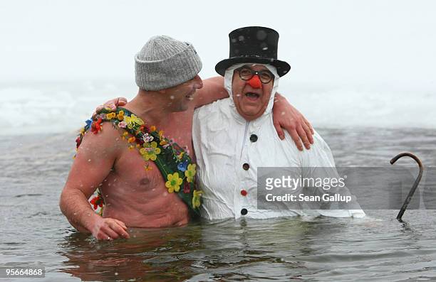 Participants take a quick dip in the frozen Orankesee lake at the 26th annual Berlin Seals winter swim on January 9, 2010 in Berlin, Germany....