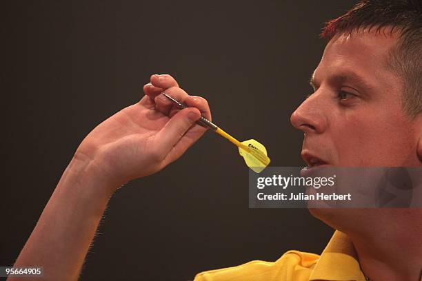 Dave Chisnall of England in action against Tony O' Shea of England during the Semi Final of The World Professional Darts Championship at Lakeside on...