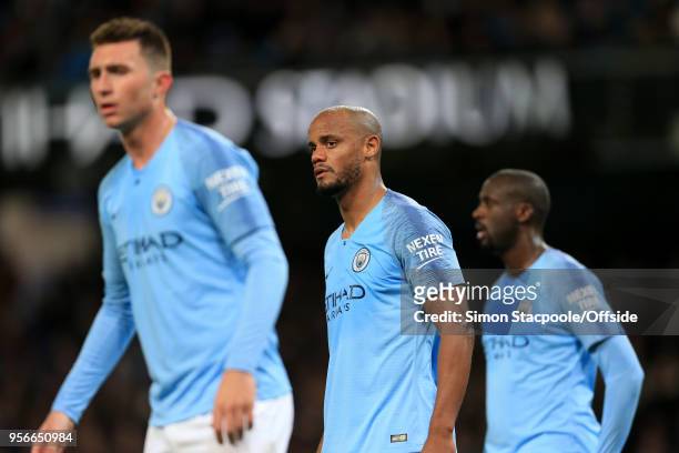 Vincent Kompany of Man City stands in between Aymeric Laporte of Man City and Yaya Toure of Man City during the Premier League match between...