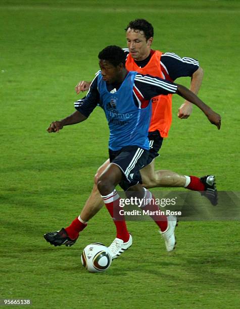 David Alaba of Bayern Muenchen and Mark van Bommel compete for the ball during the FC Bayern Muenchen training session at the Al Nasr training ground...