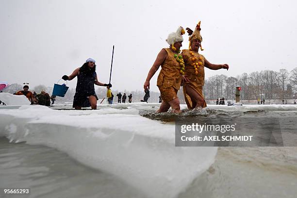 Costumed members of several winter bathing associations take the annual bath in the frozen Orankesee lake on January 10, 2010 in Berlin. Most of the...