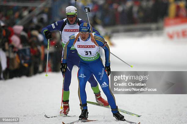 Carl-Johan Berman of Sweden leads Janez Maric of Slovenia during the men's sprint in the e.on Ruhrgas IBU Biathlon World Cup on January 09, 2010 in...