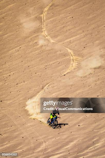 downhill mountain biker freeriding in paracas, peru. - paracas stock pictures, royalty-free photos & images