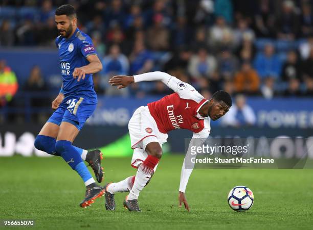 Ainsley Maitland-Niles of Arsenal breaks past Riyad Mahrez of Leicester during the Premier League match between Leicester City and Arsenal at The...
