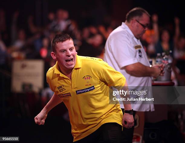 Dave Chisnall of England celebrates beating Tony O' Shea of England during the Semi Final of The World Professional Darts Championship at Lakeside on...
