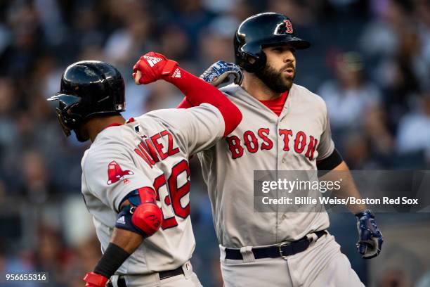 Mitch Moreland of the Boston Red Sox reacts with Eduardo Nunez after hitting a two-run home run during the second inning of a game against the New...