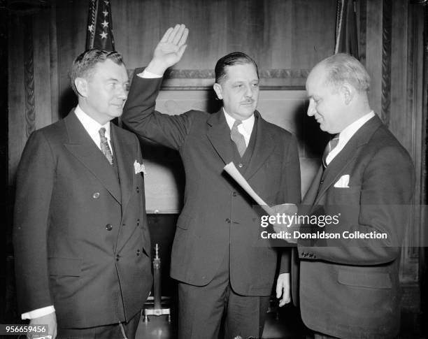 Thurman Arnold. L.R. Robert Jackson, Solicitor Gen'l; Thurman Arnold, Asst. Sol. Gen'l; Hugo Carsui, administering oath being sworn in.