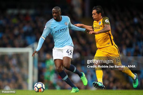 Yaya Toure of Manchester City and Leonardo Ulloa of Brighton & Hove Albion during the Premier League match between Manchester City and Brighton and...