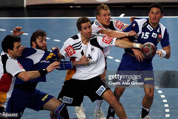Alexander Petersson and Robert Gunnarsson of Iceland is challenged by Lars Kaufmann , Oliver Roggisch and Matthias Flohr of Germany during the...