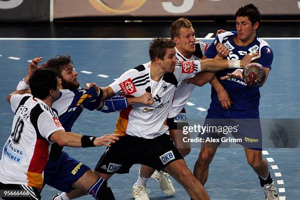 Alexander Petersson and Robert Gunnarsson of Iceland is challenged by Lars Kaufmann , Oliver Roggisch and Matthias Flohr of Germany during the...