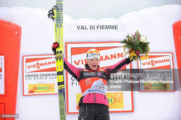 Petra Majdic of Slovenia celebrates on the podium after taking 1st place during the Women's 10km Classic Mass Start of the FIS Tour De Ski on January...