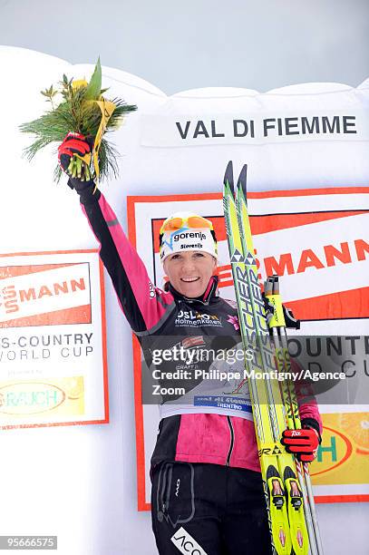 Petra Majdic of Slovenia celebrates on the podium after taking 1st place during the Women's 10km Classic Mass Start of the FIS Tour De Ski on January...