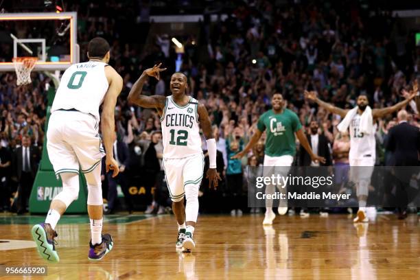 Terry Rozier of the Boston Celtics celebrates with Jayson Tatum after hitting a three point shot to end the first half against the Philadelphia 76ers...