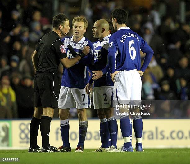 Stephen Carr of Birmingham City speaks to referee Mark Clattenburg after Scott Dann scored an own goal during the Barclays Premier League match...