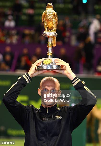 Nikolay Davydenko of Russia celebrates with the trophy following victory over Rafael Nadal of Spain in the Final match of the ATP Qatar ExxonMobil...