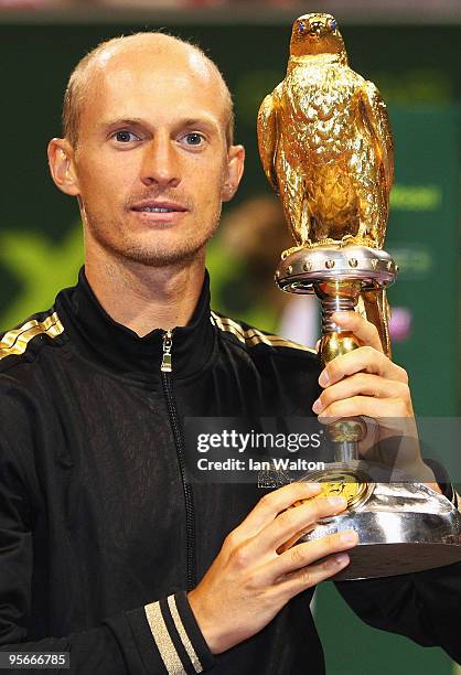Nikolay Davydenko of Russia celebrates with the trophy following victory over Rafael Nadal of Spain in the Final match of the ATP Qatar ExxonMobil...