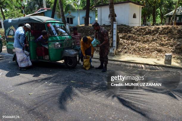 This photograph taken on April 6, 2018 shows Bangladesh Border Guard personnel searching a passenger at a checkpost along the Teknaf-Cox's Bazar...