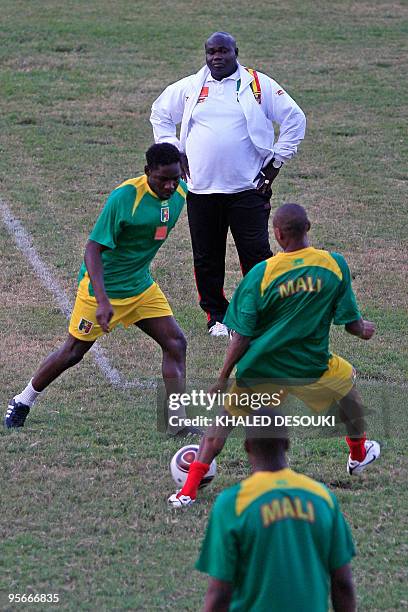 Nigerian Keshi Stephen head coach of Mali eyes his players during their training session at the Coqueiros stadium in Luanda, Angola on January 9,...