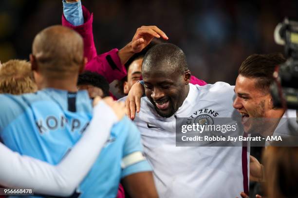 Players of Manchester City celebrate with Yaya Toure of Manchester City after he makes his final appearance for the team during the Premier League...