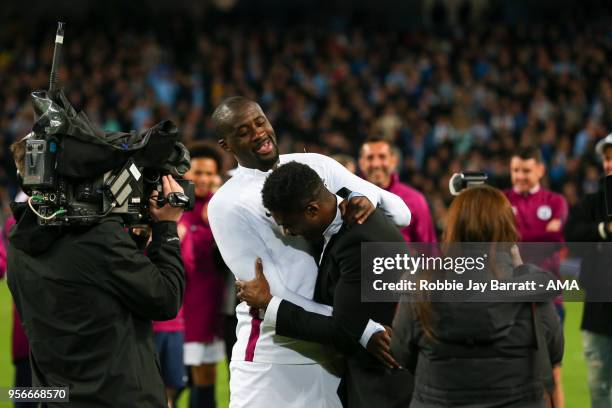 Yaya Toure of Manchester City is greeted by his brother Kolo Toure during the Premier League match between Manchester City and Brighton and Hove...