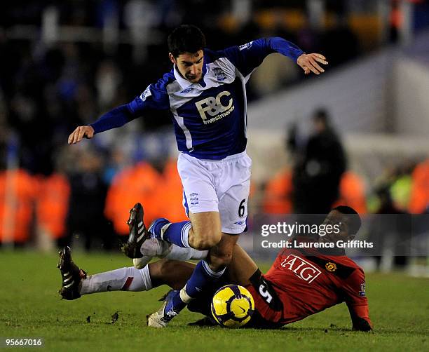 Liam Ridgewell of Birmingham City and Antonio Valencia of Manchester United battle for the ball during the Barclays Premier League match between...