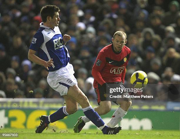 Wayne Rooney of Manchester United clashes with Scott Dann of Birmingham City during the FA Barclays Premier League match between Birmingham City and...