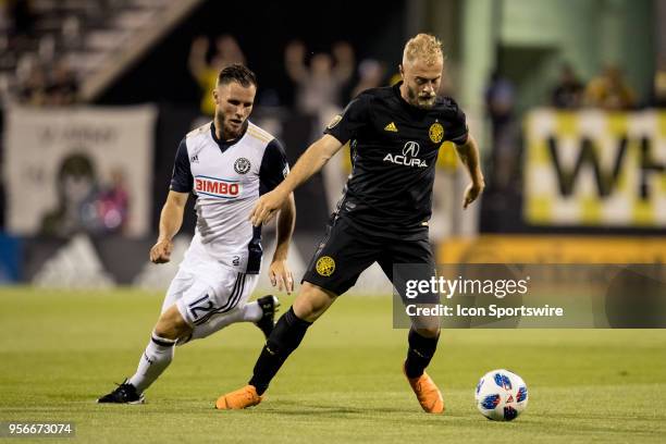 Columbus Crew midfielder Mike Grella keeps the ball from Philadelphia Union defender Keegan Rosenberry in the MLS regular season game between the...