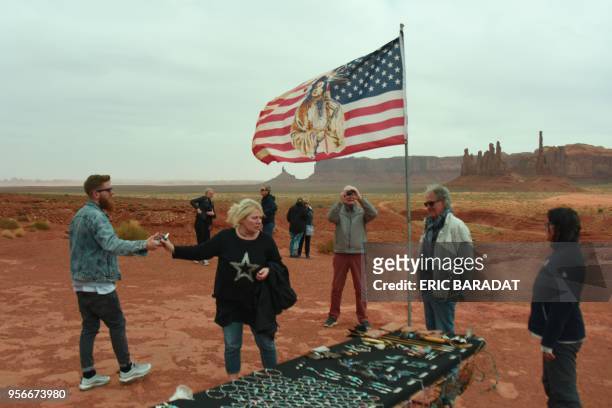 Tourists buy native American Najavo handicraft inside the Monument Valley Park on April 19, 2018. - Monument Valley is a region of the Colorado...