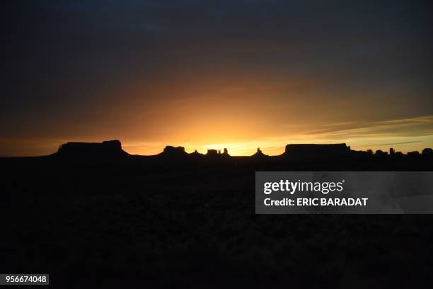 The sun rises over the Monument Valley on April 19, 2018. - Monument Valley is a region of the Colorado Plateau characterized by a cluster of vast...