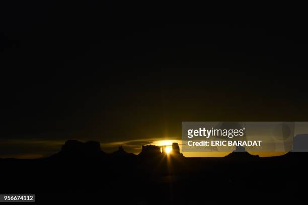 The sun rises over the Monument Valley on April 19, 2018. - Monument Valley is a region of the Colorado Plateau characterized by a cluster of vast...
