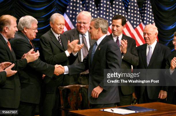 President George W. Bush shakes hands with Speaker of the House Dennis Hastert and other lawmakers after signing legislation, the Partial Birth...